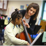 Hillary Harder with young cello student