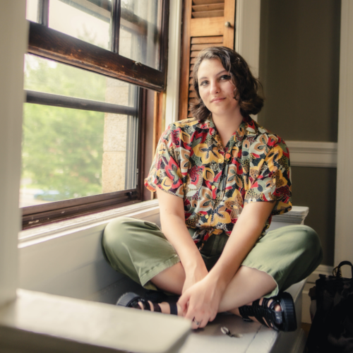 Mary Denney sitting by a window at Longy